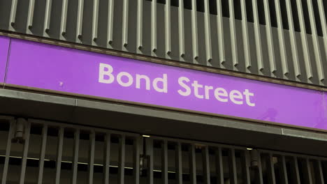 Bond-Street-Overground-station-sign-close-up-exit-Russell-Square-London-Day-Exterior