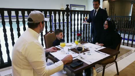 Happy-Arab-Family-At-A-Restaurant---Wide-Shot