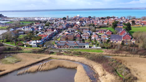 Aerial-flying-away-from-Isle-of-Wight-village-Sunny-day-UK-4K