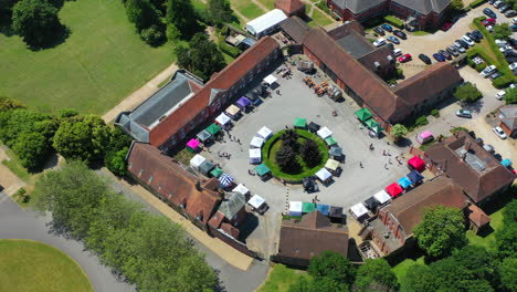 Aerial-panning-around-Ashford-Hangers-market-Sunny-day-UK-4K