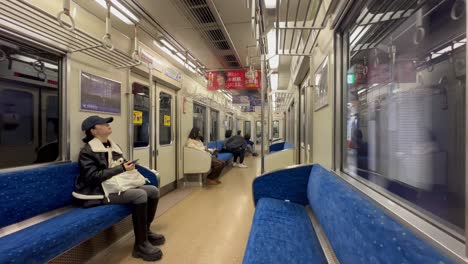 A-Woman-Passenger-On-A-Public-Underground-Train-In-Tokyo,-Japan