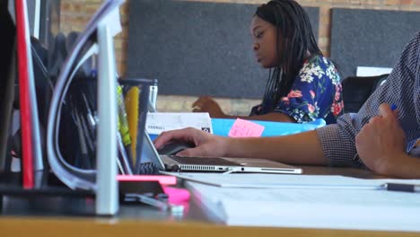 Diverse-employees-working-at-desk