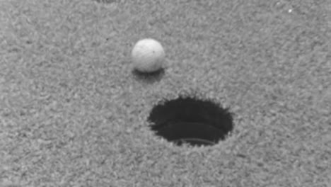 Close-Up-View-of-a-Golf-Ball-on-the-Verge-of-Dropping-Into-the-Hole