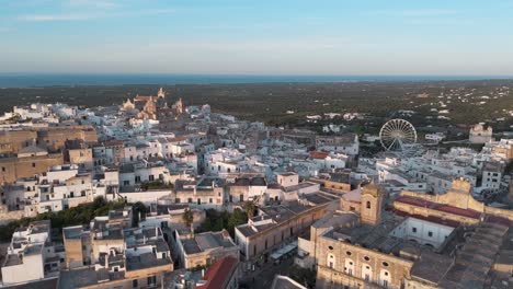 Aerial-View-of-a-Historic-Mediterranean-Town-Ostuni-with-Ferris-Wheel