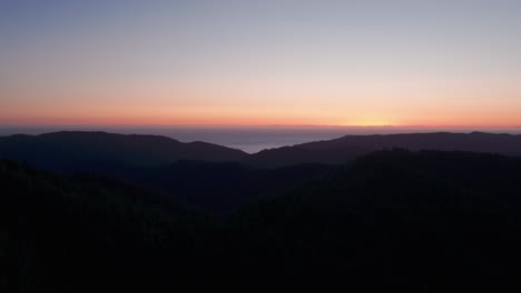 Aerial-drone-shot-of-the-mountain-silhouette-at-sunset