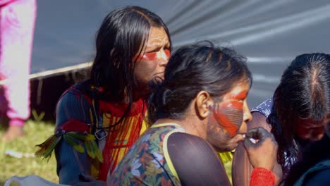 Amazonian-Women-Tribe-Members-Seated-in-Traditional-Clothing,-Slow-Motion