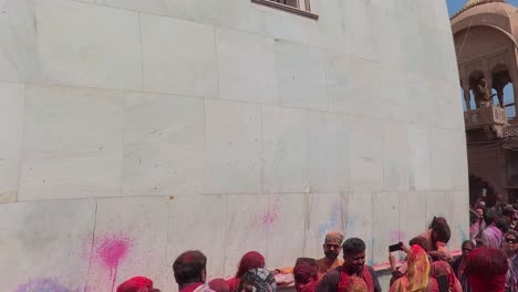 pov-shot-Many-people-are-blowing-colors-from-inside-the-temple-and-people-are-enjoying-different-colors-outside