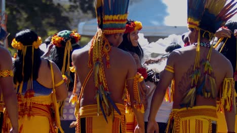 An-indigenous-tribe,-all-wearing-the-same-colorful-clothing-and-headgear