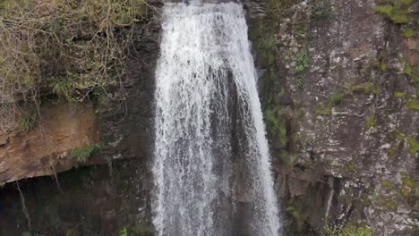 Eine-Zeitlupen-Luftaufnahme-Des-Melinclourt-Wasserfalls-An-Einem-Bewölkten-Tag,-Neath-Port-Talbot,-Südwales