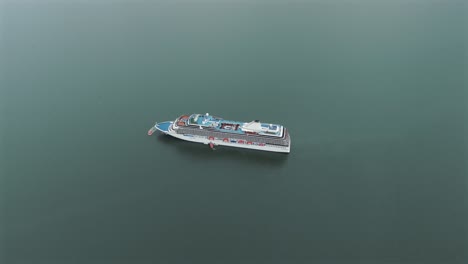 Drone-view-of-security-drill-of-luxury-cruise-ship-docked-in-Babitonga-Bay,-Brazil