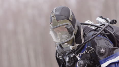 Dripping-water-from-ice-diver-after-penetration-dive-in-iced-lake,-closeup