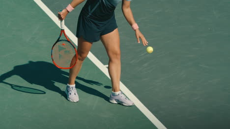 Tennis-player-bouncing-ball-before-serve-in-extreme-slow-motion,-pro-tennis-female-preparing-for-point-in-4k-800fps-on-sunny-day