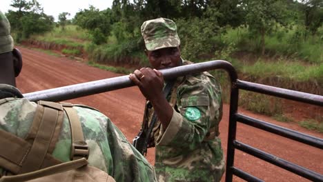 Park-rangers-jumping-off-a-pick-up-truck-in-Rwanda