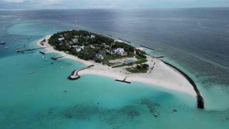 Aerial-drone-video-slowly-panning-around-the-local-island-of-Fulidhoo-in-the-Maldives,-early-in-the-morning