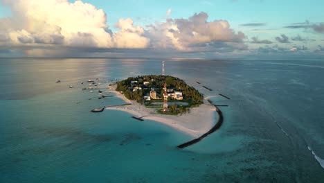 Aerial-drone-video-panning-around-the-island-of-Fulidhoo-early-in-the-morning-in-the-Vaavu-Atoll,-Maldives