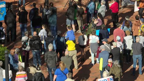 Crowd-of-Democrats-with-Biden-Harris-Banner-protesting-in-front-of-republican-event-in-american-town