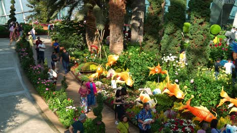 Panning-view-of-Flower-Field-with-dragon-theme-display-in-the-center-to-celebrate-Chinese-Lunar-New-Year-at-Flower-Dome-glass-greenhouse-conservatory-at-Gardens-by-the-bay-during-festive-season