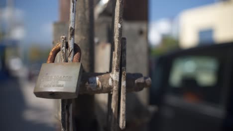 Close-up-tight-shot-of-an-old-rusty-padlock-securing-a-lever-on-electricity-pole-4K