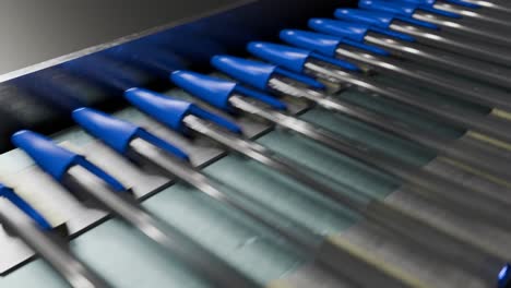 3D-animation-of-blue-pens-moving-down-a-conveyor-belt-in-a-factory