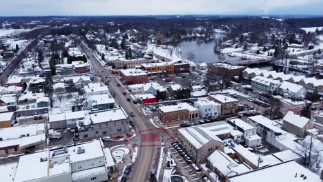 aerial-flyover-of-a-suburban-downtown-during-winter