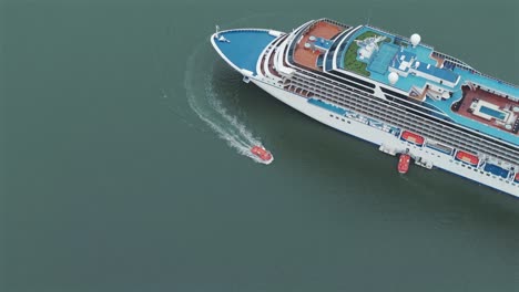 Lifeboat-navigates-around-a-cruise-ship-docked-in-Babitonga-Bay