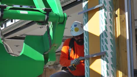 Construction-worker-drills-into-drywall