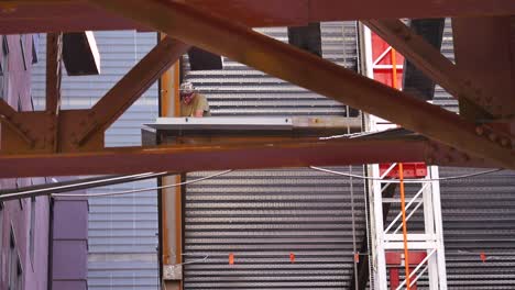 Slow-motion-shot-of-man-welding-and-working-on-steel-beams