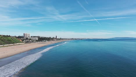 Drone-shot-flying-backwards-down-Santa-Monica-Beach-in-California