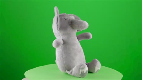 Stuffed-elephant-doll-toy-for-newborn-baby-soft-fluffy-present-friend-soft-in-a-turntable-with-green-screen-for-background-removal-3d