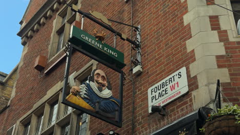 Close-up-of-pub-sign-on-Foubert's-Place,-Shakespeare's-Head-pub,-Carnaby-Street,-London,-Wide-Shot,-Day,-Exterior