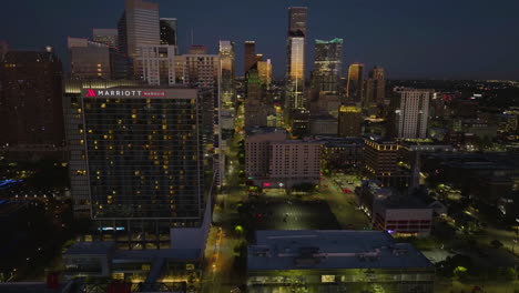 Aerial-tracking-shot-of-the-Marriott-Marquis-hotel-and-the-skyline,-dawn-in-Houston