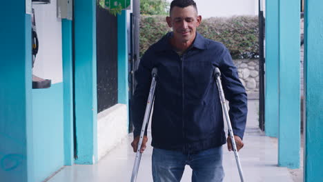long-shot-of-man-with-crutches-standing-waiting