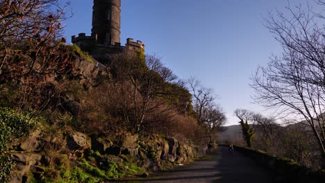 View-along-walking-path-below-Calton-Hill-Hill,-Edinburgh,-Scotland