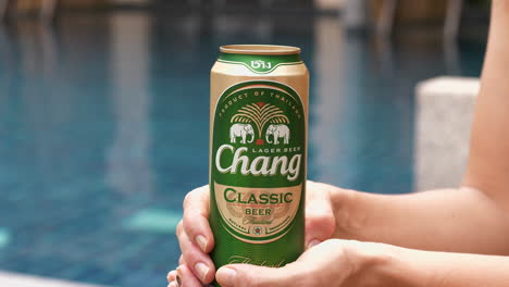 Static-close-up-view-of-a-Chang-beer-can-in-a-woman's-hand