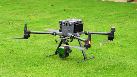 Large-industrial-drone-with-lidar-system-camera-payload-on-green-grass