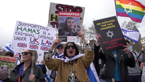 Pro-Israeli-people-dance-while-holding-various-placards,-some-that-read,-“We-survived-the-gas-chambers,-we’ll-survive-your-gaslighting”,-on-a-counter-protest-to-the-annual-Al-Quds-day-demonstration