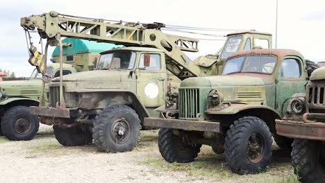 A-line-of-old-antique-abandoned-used-rusty-trucks-outside