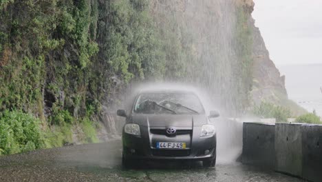 Shot-of-Anjos-Waterfall-in-Madeira,-Car-Crossing-Water-Cascade