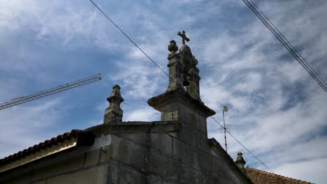 Rooftop-Statues-on-Chapel-A-Siota,-Xunqueira-de-Ambia,-Spain