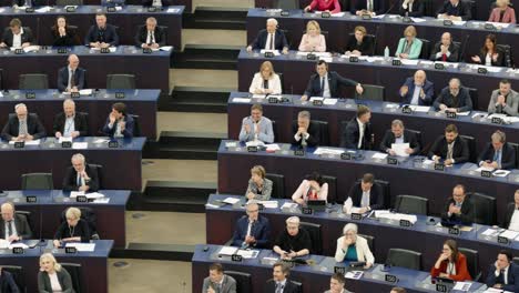 European-Parliament-plenary-hall-with-members-applauding-during-EU-plenary-session-in-Strasbourg,-France---Panning-shot