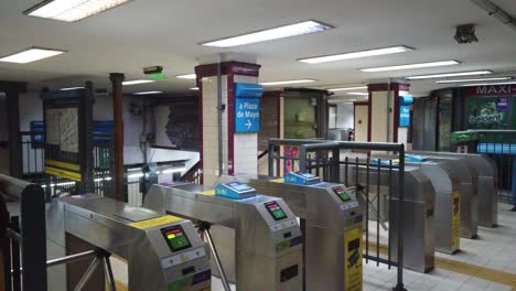 Metallic-Turnstiles-entrance,-vintage-underground-subway-station-panorama-empty-in-south-American-capital-city,-Primera-Junta,-Line-A-metro-station