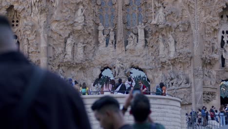 Busy-crowd-in-front-of-Sagrada-Familia-in-Barcelona,-tourists-enjoying-the-iconic-architecture