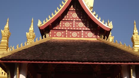 Red-temple-in-front-of-Pha-That-Luang-Golden-Stupa-in-Vientiane,-Laos