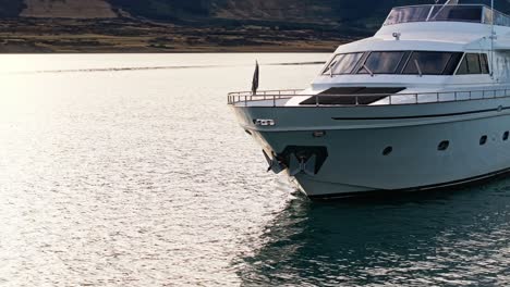 Closeup-aerial-orbit-around-front-of-yacht-with-anchors-as-reflections-glisten-in-windows