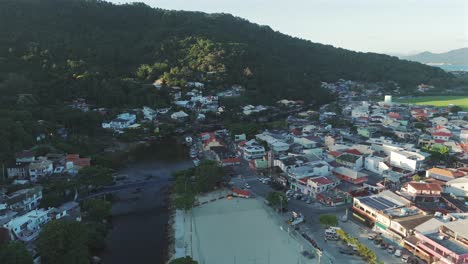 Aerial-view-of-the-canal-and-urban-area-of-the-Barra-da-Lagoa-district-in-Florianópolis,-Brazil