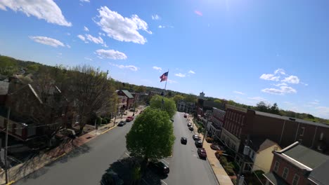 FPV-drone-shot-over-American-town-square-during-spring-day