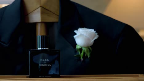 Groom-wedding-accessories-before-the-ceremony-detail-shot,-parfume,-Costume-with-white-rose-inside-front-pocket