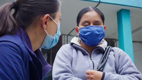 Detail-shot-of-women-with-masks-talking