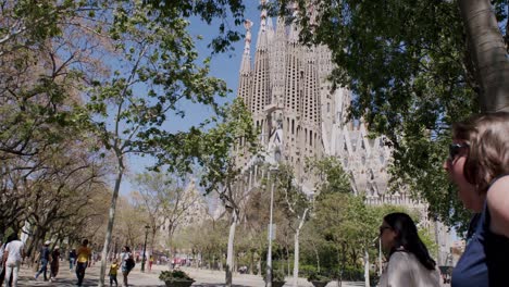 Blurred-cyclist-speeds-past-the-Sagrada-Familia-in-sunny-Barcelona