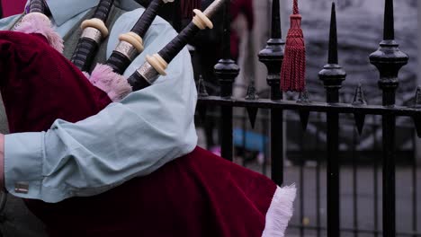 Close-detailed-shot-of-bagpipes-being-played-by-street-performer,-Edinburgh,-Scotland